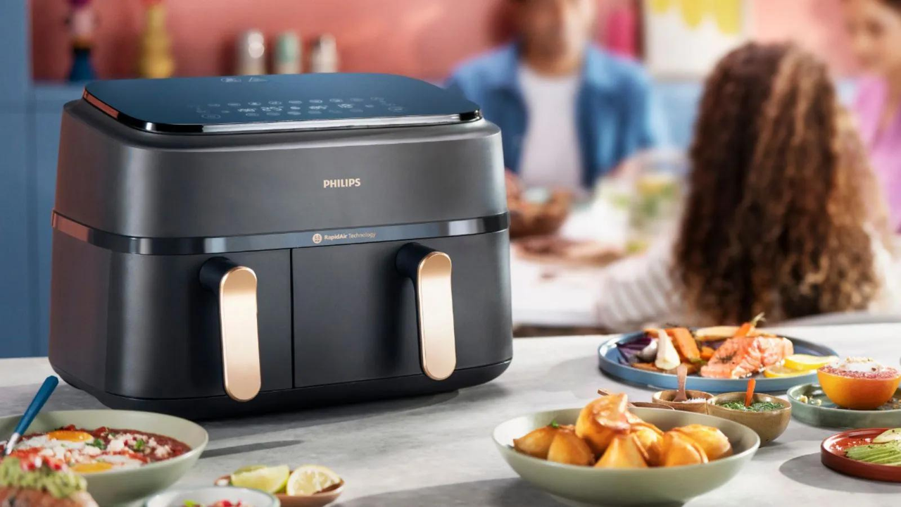 A white air fryer plugged in on a kitchen side