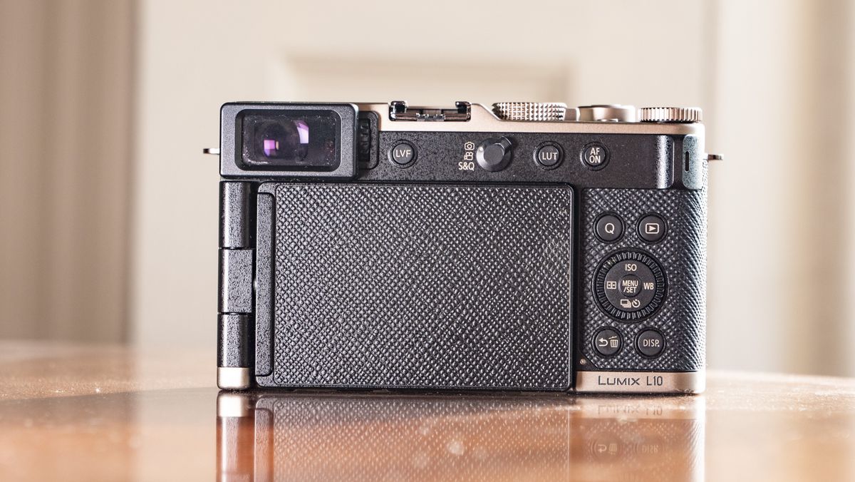 Rear of the Titanium Gold special edition of the Panasonic Lumix L10 compact camera, on an antique wooden table