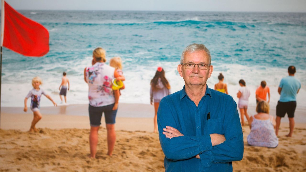 Martin Parr stands with his work from Porthcurno, Cornwall.