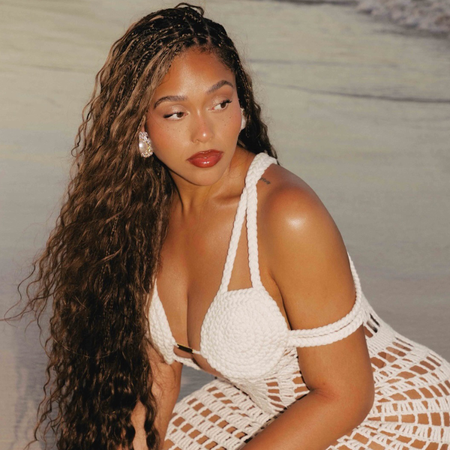Jordyn Woods wearing white bachlorette outfit for brides crochet white dress.