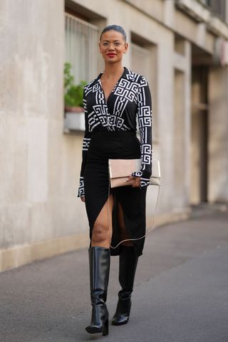 A woman wearing knee high boots