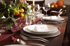 Table settings with place cards and autumn foliage