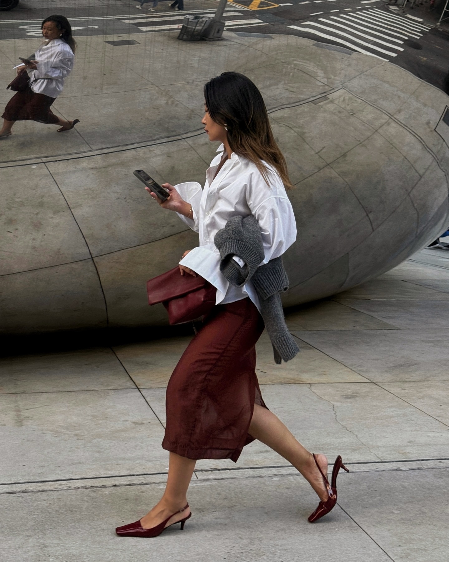 @thecaroline.lin wears a white shirt, burgundy skirt and burgundy kitten-heel shoes