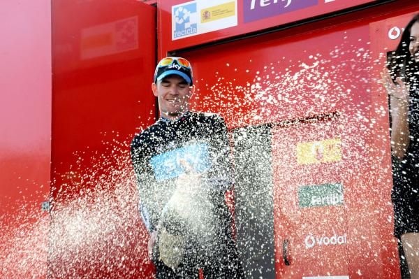 Chris Sutton (Sky) celebrates on the podium.