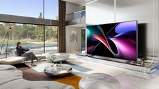 Promotional photo showing the Hisense 116" UX RGB-Mini LED TV in a beautiful and expensive-looking room with huge windows and lots of natural light