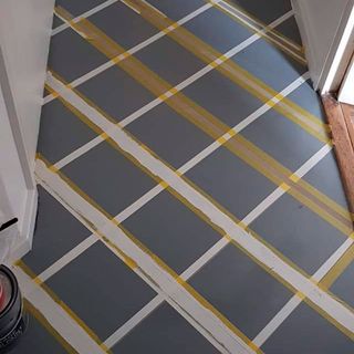 hallway with grey tile painted floor