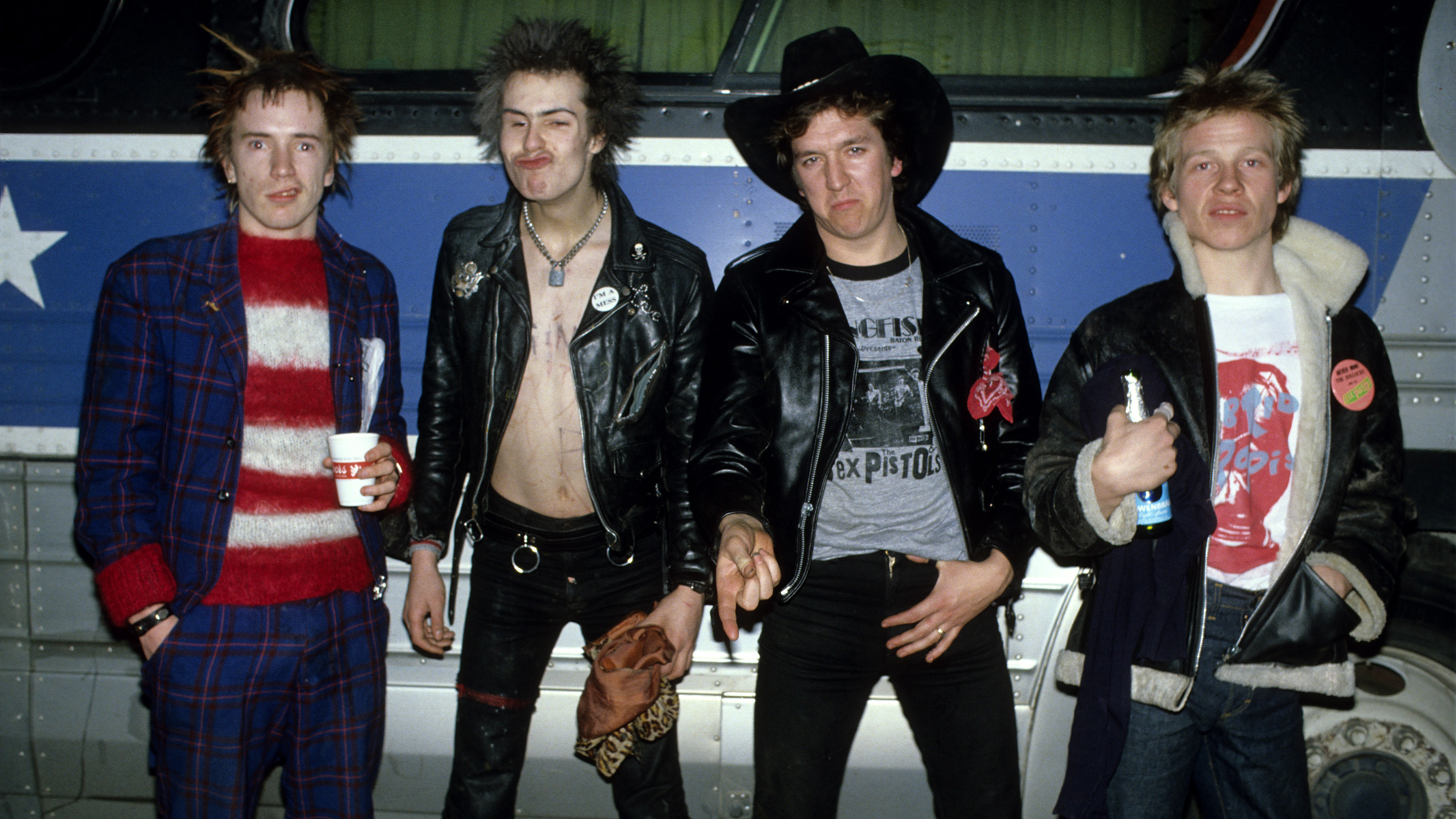 Sex Pistols, group portrait in front of bus during their final tour