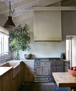 neutral kitchen with reclaimed oak cabinets and limestone worktops and sink