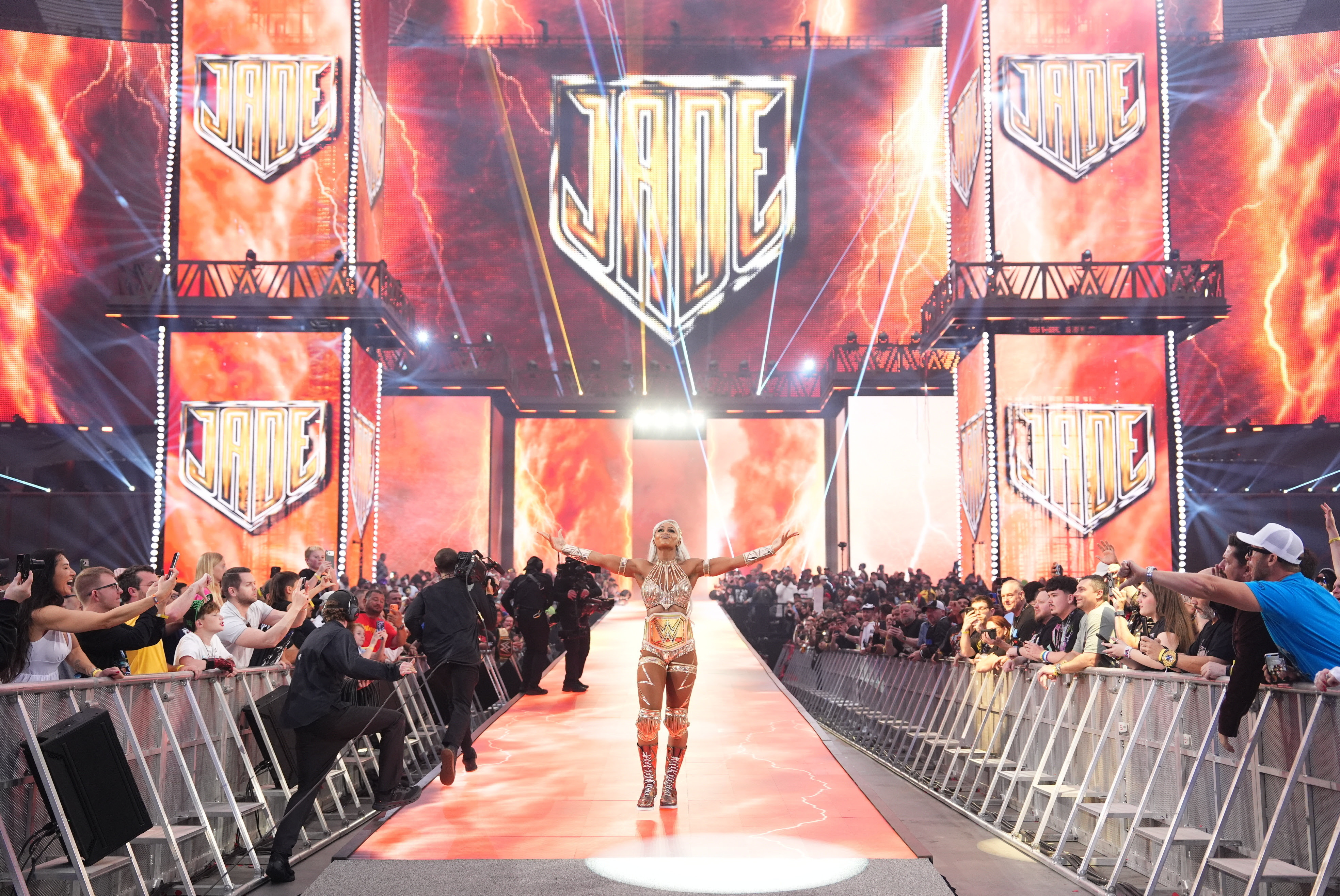 Scenes from WWE Wreslemania 42 with wrestlers making entrances in front of huge digital displays.