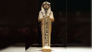A shabti found in Tutankhamun's tomb. Shabtis are commonly found in ancient Egyptian tombs and were meant to serve the deceased in the afterlife. This shabti is made of limestone and is holding a crook and flail.