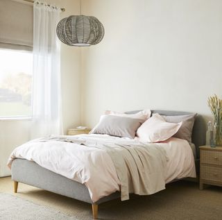 bedroom with grey bed and cushions