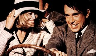 Bonnie and Clyde Faye Dunaway and Warren Beatty are smiling as they'e joy riding