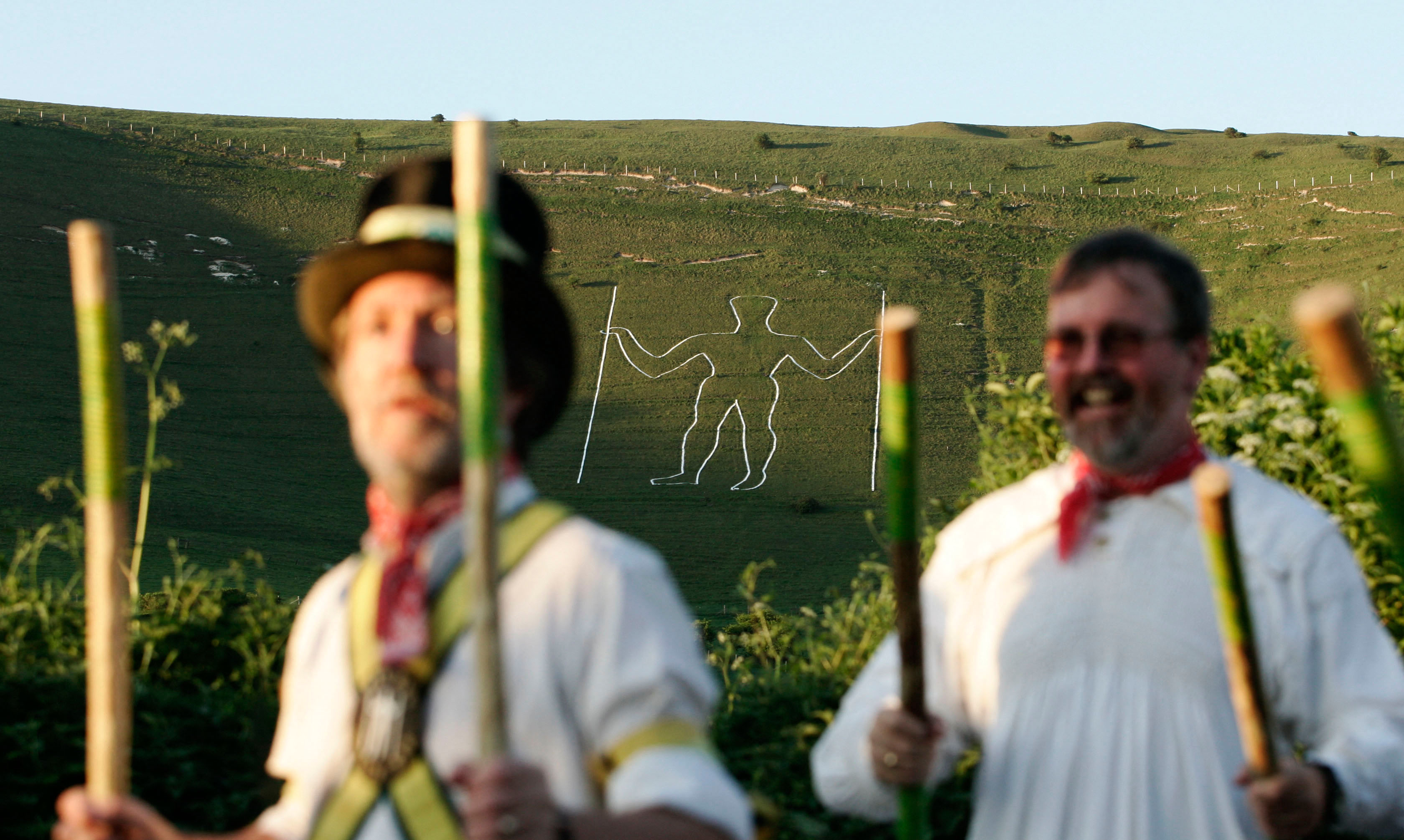 Morris Men dance at the foot of the Long Man of Wilmington as the sun rises on May 1, 2007.