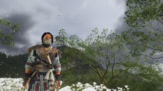 Ghost of Yotei screenshot featuring Atsu on a hill with flowers