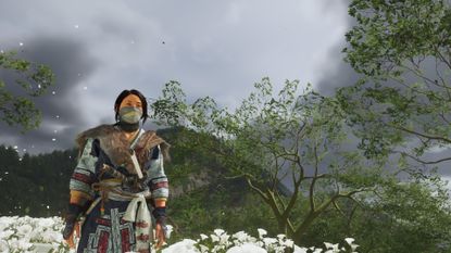 Ghost of Yotei screenshot featuring Atsu on a hill with flowers