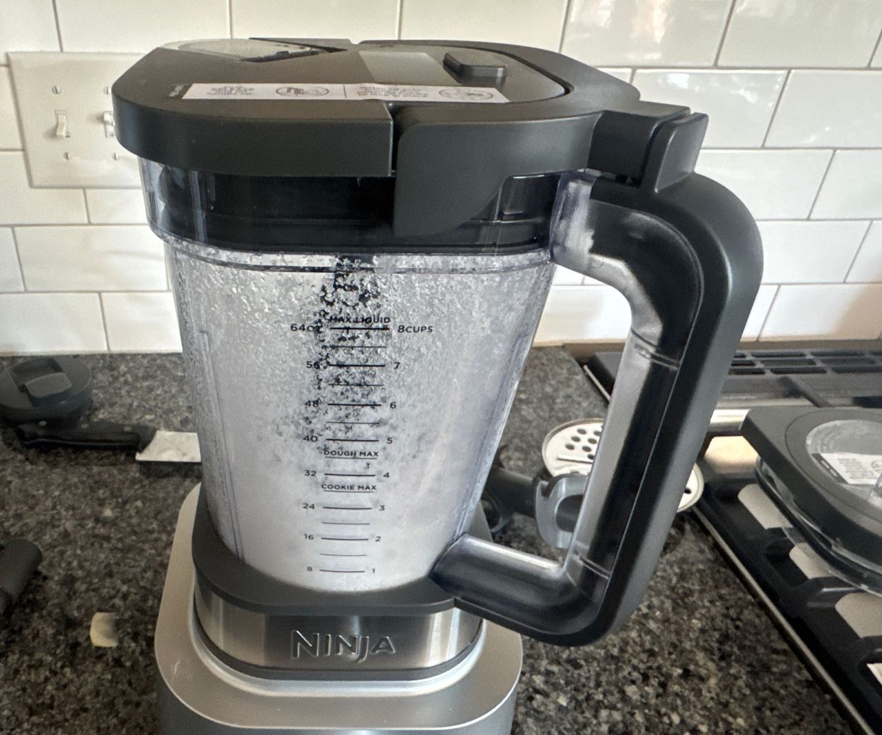 Ice crushed inside the Ninja Foodi Power Blender Ultimate System, resembling a fine powder.