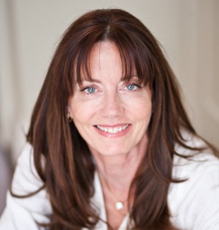 Female with long brown hair smiling wearing white shirt