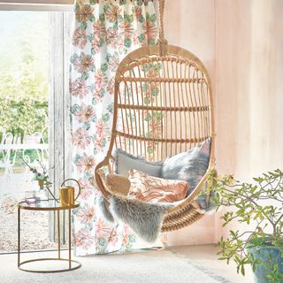 hanging chair with cushions and side table