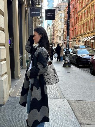 Fashion influencer @mimixn in New York City wearing a chic winter outfit featuring the snake print micro-trend.