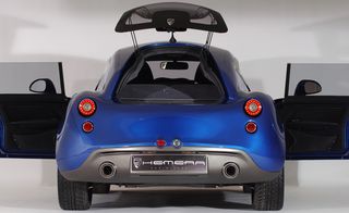 Rear view of a small blue 'Hemera' sports car, doors and boot open, white background