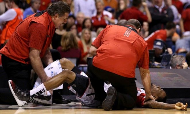 Medics try to calm Kevin Ware after a brutal injury, at Lucas Oil Stadium, March 31.