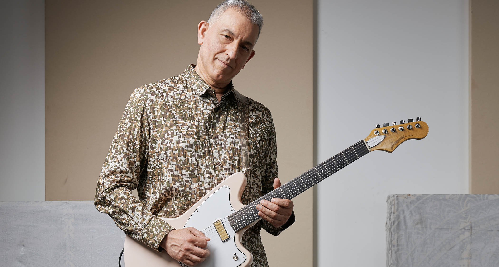 Aziz Ibrahim is photographed at home with some of his favourite guitars
