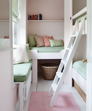 How to arrange a small bedroom for children, with white built-in furniture and pale green and pink soft furnishings.