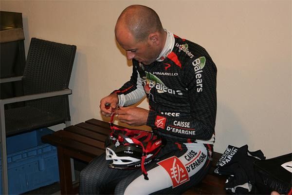 Constantino Zaballa trims his helmet straps and uses a lighter to stop them fraying.
