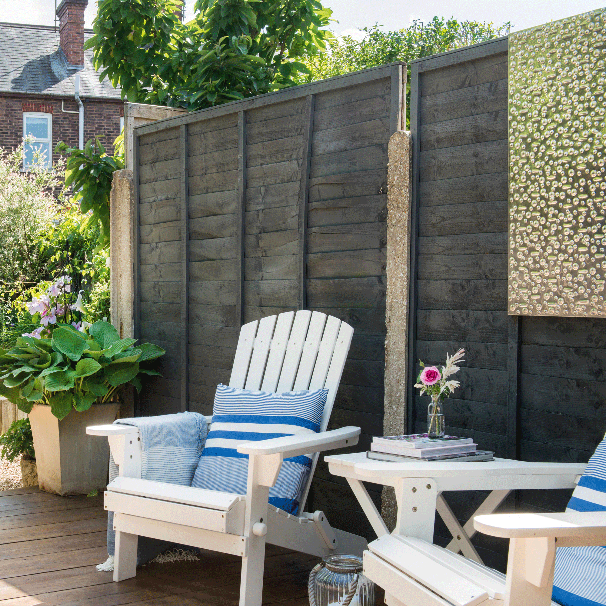 a garden with a small seating area in a garden with a pair of Adirondack chairs