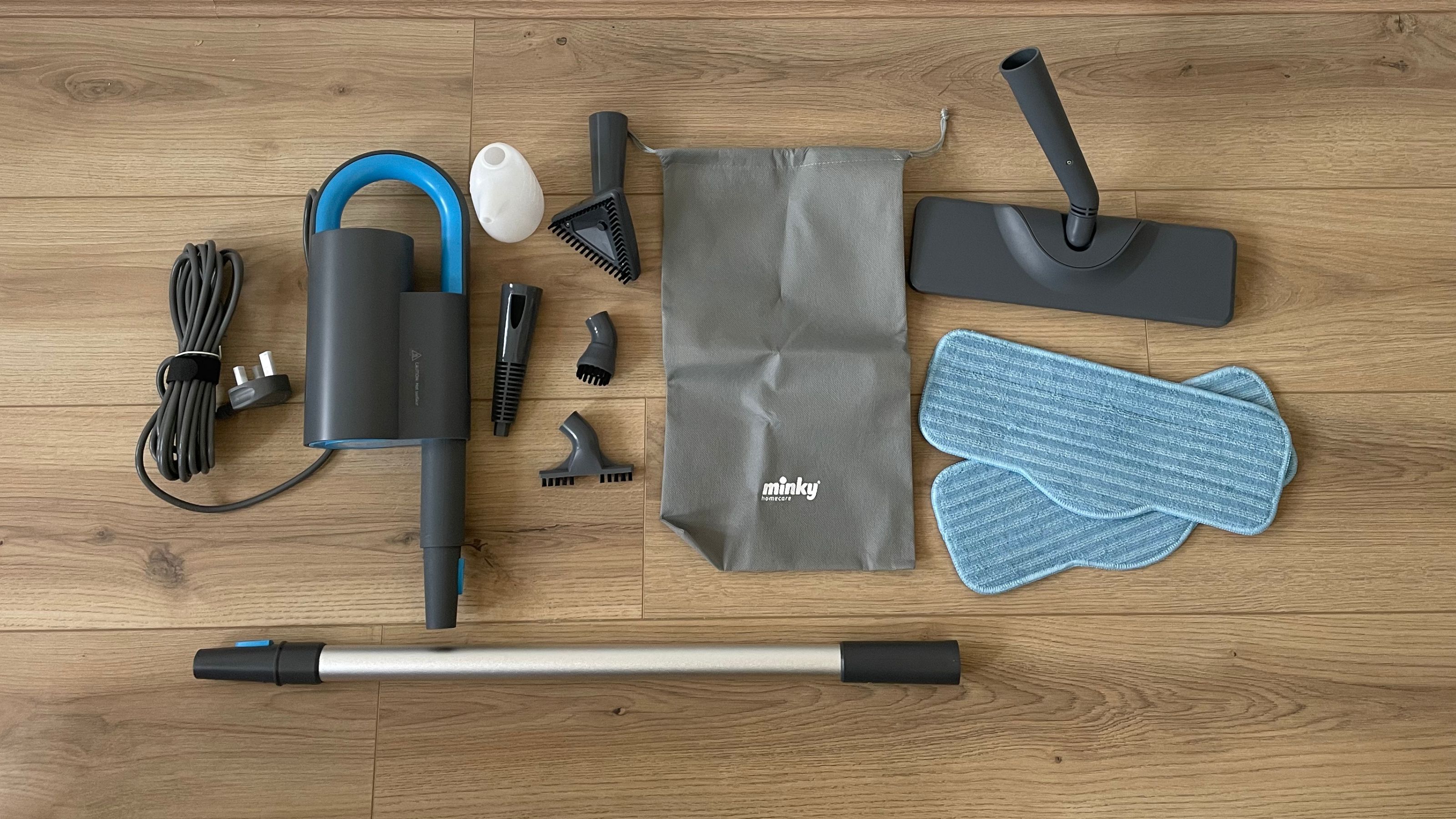 Minky Opti-Clean Steam Cleaner components laid out on wooden floor