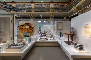 A display of furniture on plinths, shown inside the Victoria & Albert Museum library