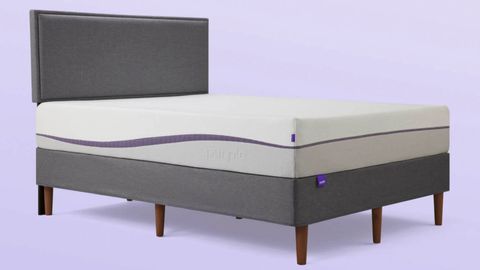 Purple Plus mattress review: The Purple Plus mattress shown from the side on a gray fabric bed base