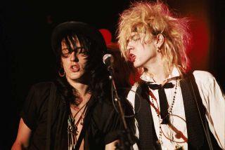 Izzy Stradlin and Duff McKagan onstage