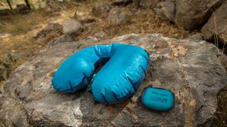 A blue Sea to Summit Aeros Ultralight Traveller Pillow and case on a rock