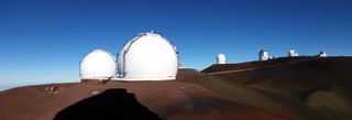 From left to right: the twin domes of Keck, NASA's Infrared Telescope Facility (mostly hidden behind the right Keck dome), Canada-France-Hawaii Telescope, Gemini North Telescope (silver dome), United Kingdom Infrared Telescope, UH Hilo Educational Telescope.