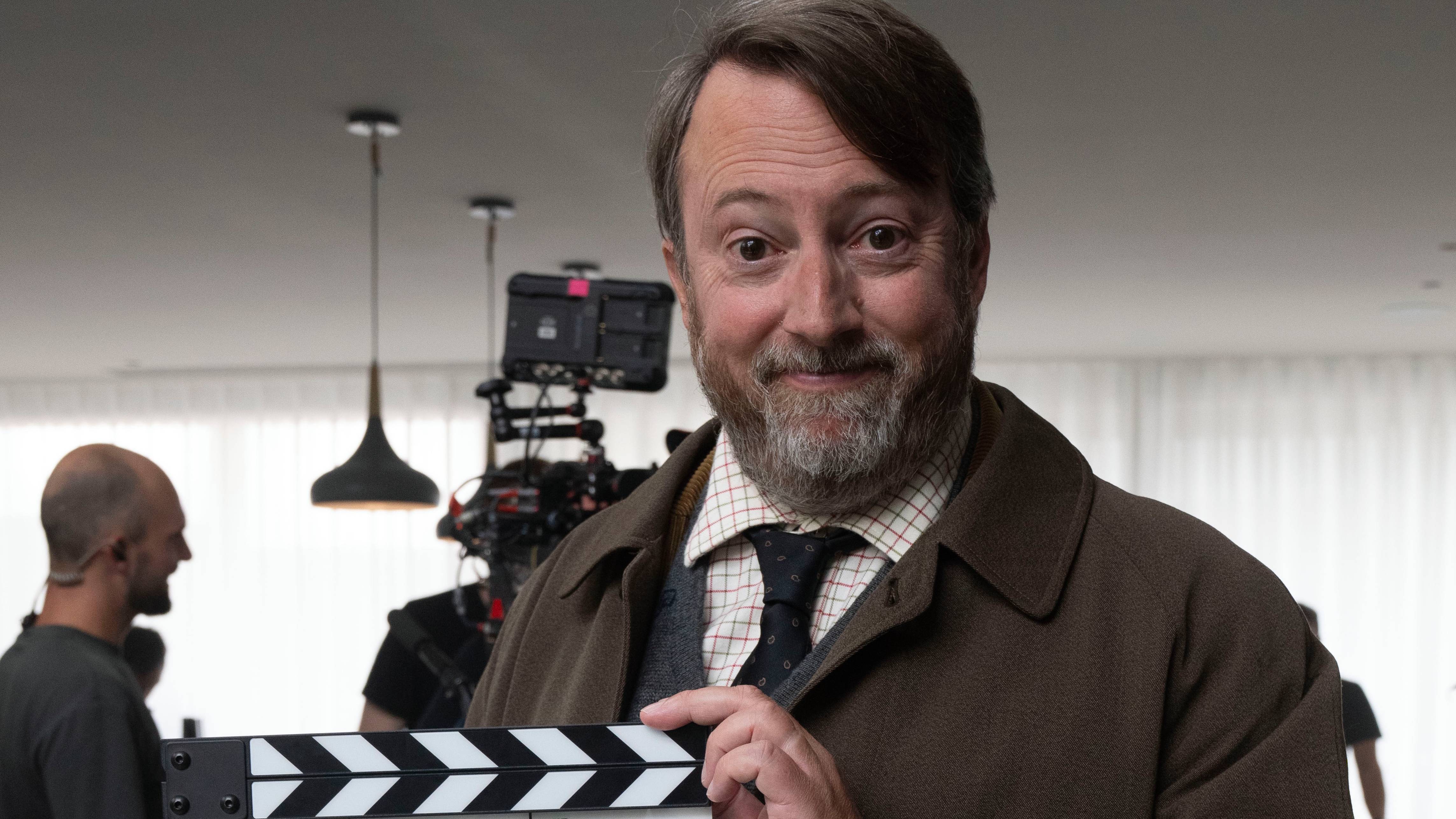 David Mitchell as Ludwig holding a clapperboard to signal starting of season 2 filming