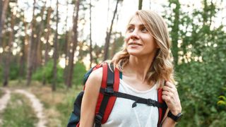 a photo of a woman hiking with a backpack