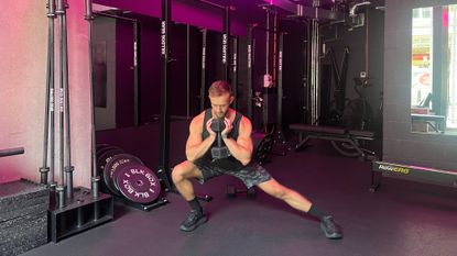 Man doing dumbbell side lunge