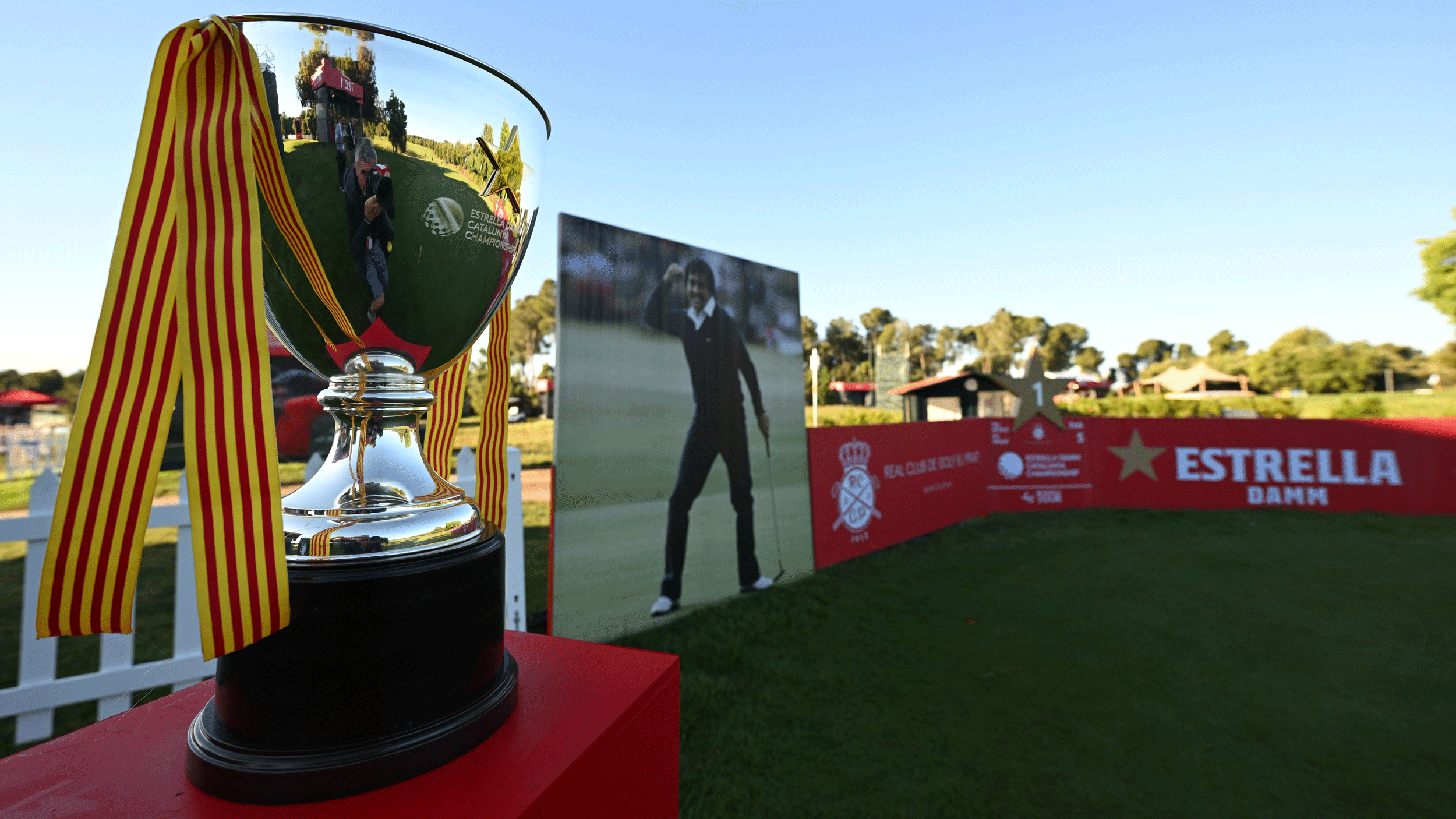 A general view of the Catalunya Championship trophy in the foreground and an iconic photo of Seve Ballesteros standing between sponsor boards behind a tee box