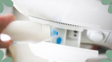 picture of person pouring fabric conditioner in laundry drawer