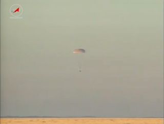The Russian Soyuz TMA-09M spacecraft carrying the Olympic torch and three Expedition 37 crewmembers home from the International Space Station nears a 'bull's eye' landing on the steppe of Kazakhstan on Nov. 11, 2013 local time (Nov. 10 EST) to end a 166-d