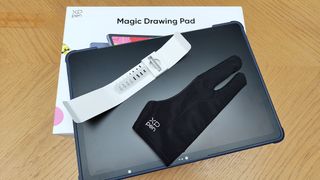 XPPen Magic Drawing Pad review; a tablet, glove, stylus on a box