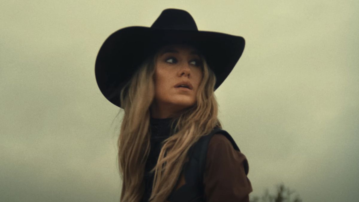 Lainey wilson in black hat in music video for &quot;Wild Flowers and Wild Horses&quot;