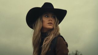 Lainey wilson in black hat in music video for "Wild Flowers and Wild Horses"