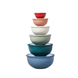 A stack of six colorful bowls with lids