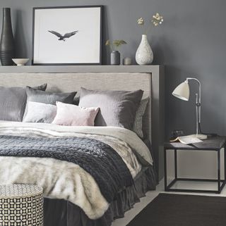 Grey bedroom with headboard as a shelf