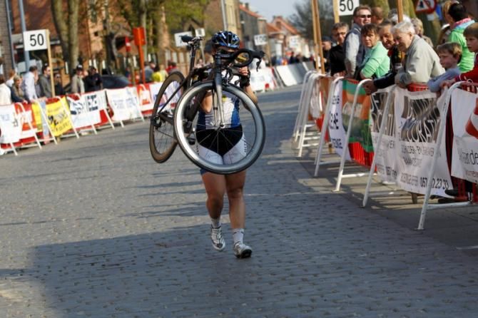 Chloe Hosking (Hitec Products) carried her bike over the line to finish with the same time as the bunch
