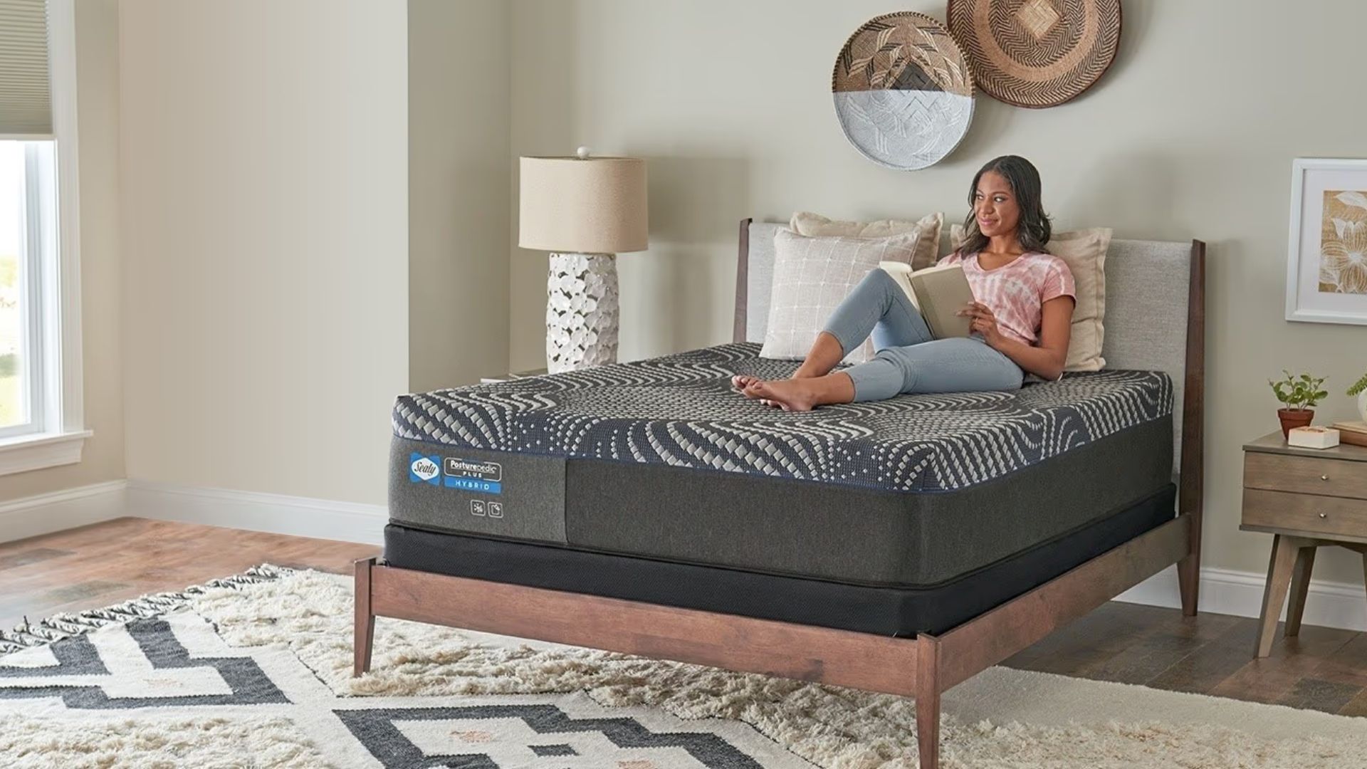 Woman relaxes on the Sealy Posturepedic Plus