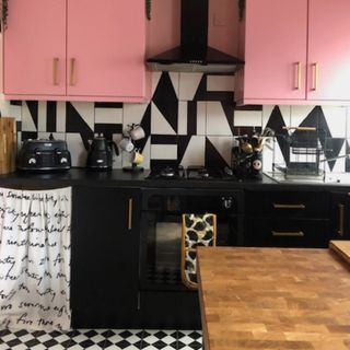 monochrome kitchen with pink wall cabinets