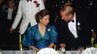 Princess Anne Seated At Dinner At The Berkeley Square Ball In London.